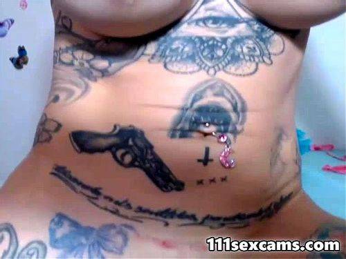 Tattoo camgirl shoves huge dildo
