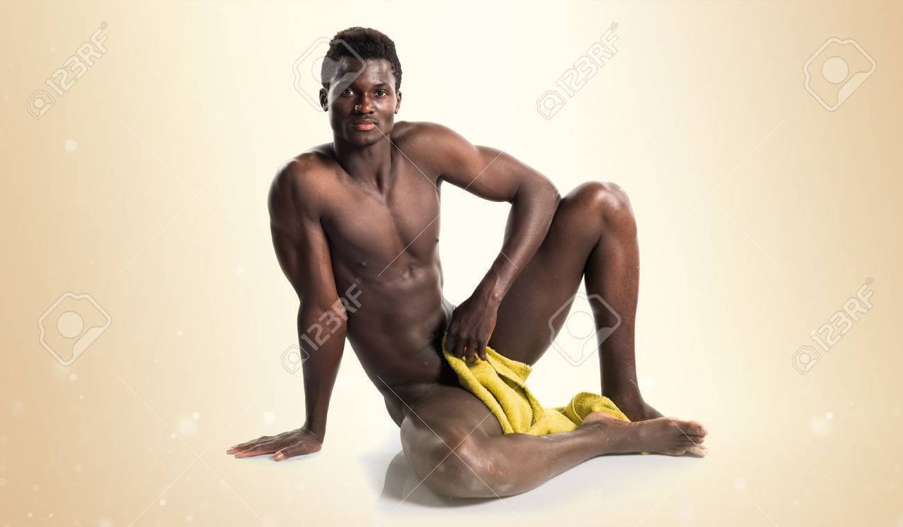 Naked black guy sitting on bed