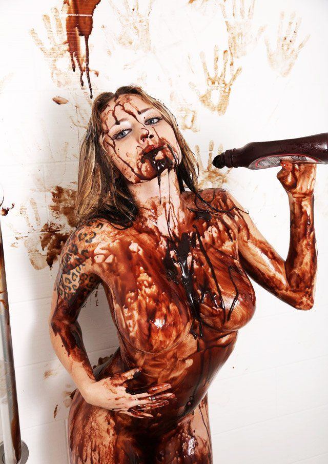Naked girl covered in chocolate sauce